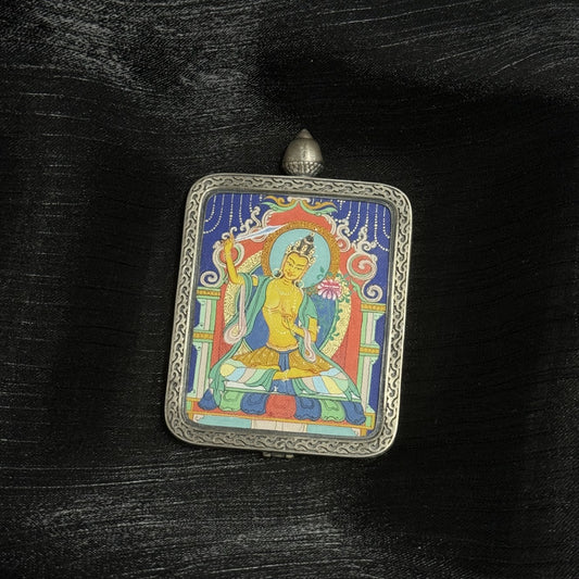 Close-up of Manjushri Bodhisattva thangka painting showing detailed mineral pigment brushwork and ornate silver gawu frame inspired by Dunhuang Nine-Color Deer design