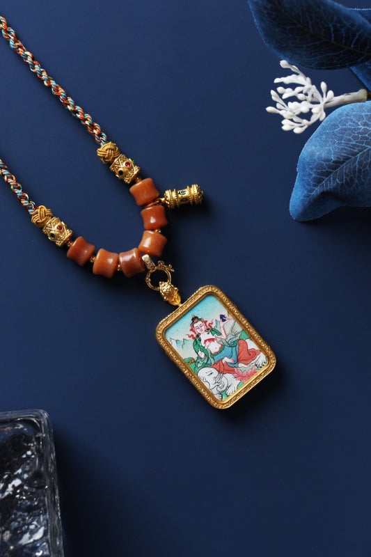 Tibetan Samantabhadra Bodhisattva mini thangka pendant displayed with braided cord necklace, metal bead accents, and protective pendant structure