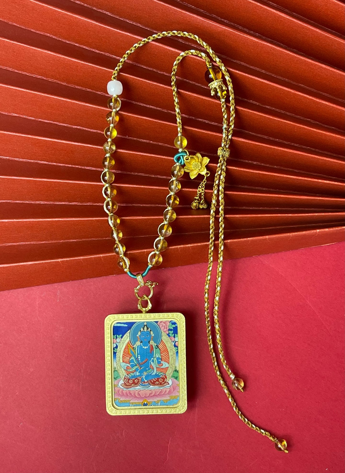 Full view of Akashagarbha Bodhisattva Tibetan Thangka pendant necklace with adjustable handwoven cord and beads