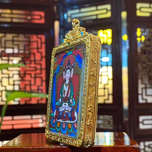 Detail view of a double-sided hand-painted Vairocana Buddha mini thangka pendant in a gold-plated copper Gawu box, showing refined Tibetan craftsmanship, 55×45mm