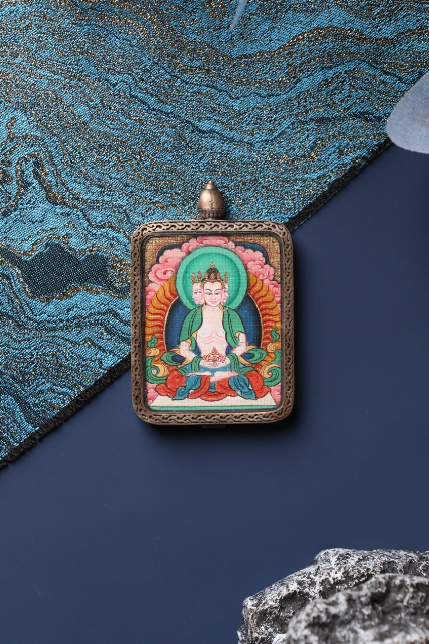 Close-up view of the hand-painted Vairocana Buddha mini thangka pendant, showing detailed mineral pigment colors and traditional Tibetan iconography