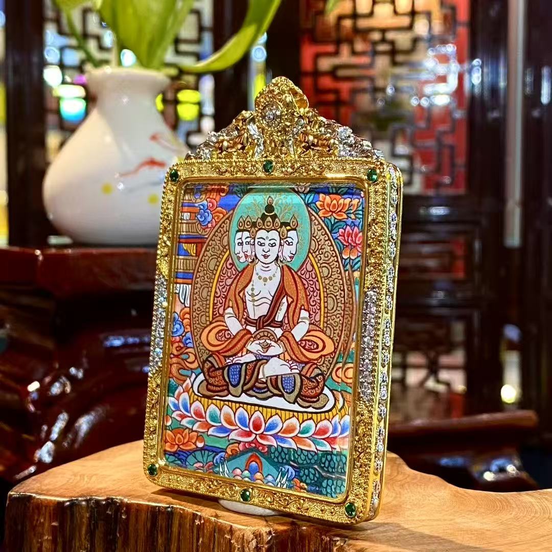 Detail view of a Vairocana Buddha mini thangka pendant with a hand-painted front and gold-plated copper Gawu box with Dharma Wheel back, 56×45mm