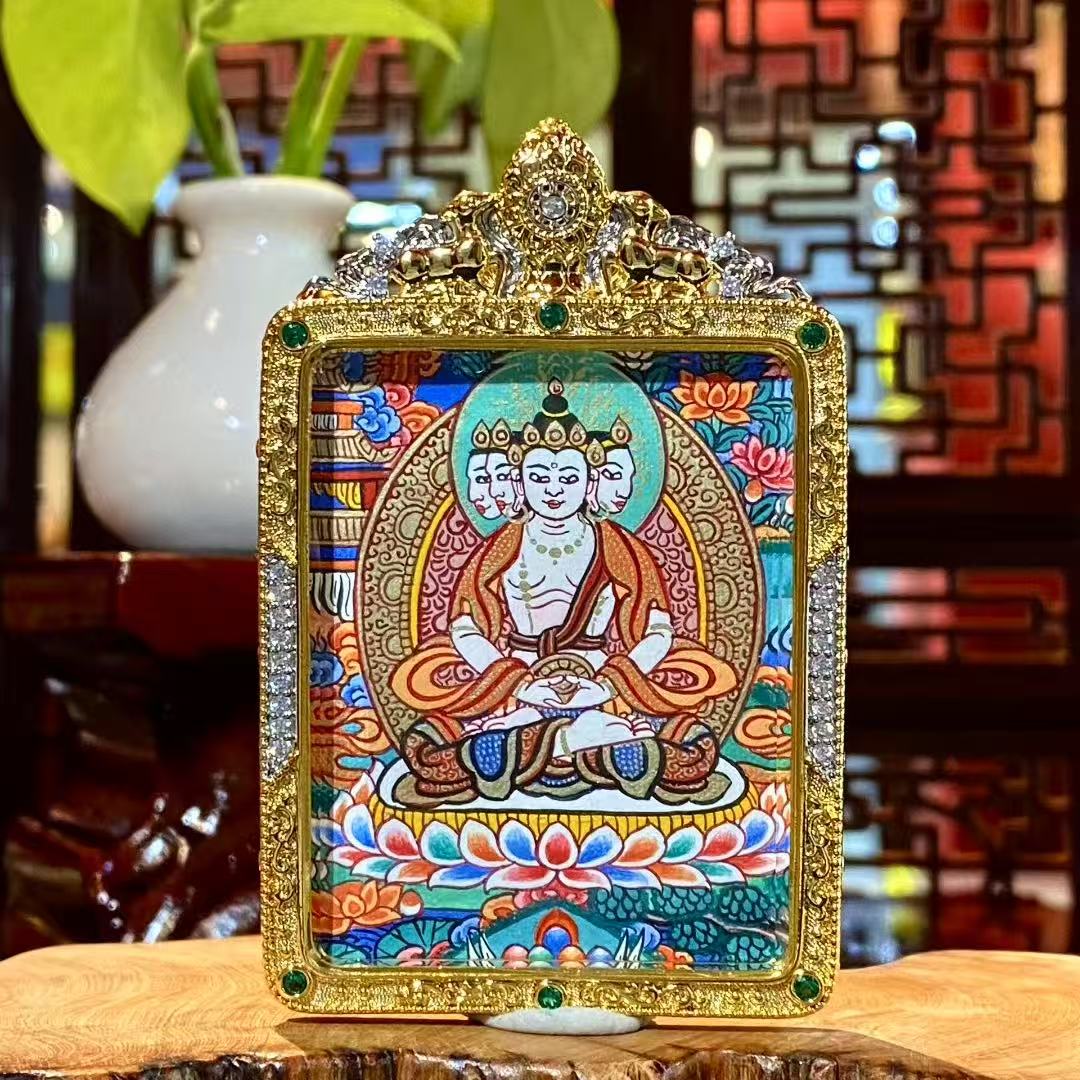 Hand-painted front view of a Vairocana Buddha mini thangka pendant set in a gold-plated copper Gawu box, single-sided painting, 56×45mm