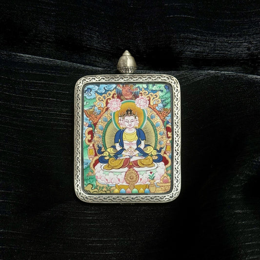 Front view of Vairocana Buddha mini thangka pendant, hand-painted with natural mineral pigments, set in Dunhuang Nine-Color Deer silver gawu case, 4x5cm Tibetan artwork.
