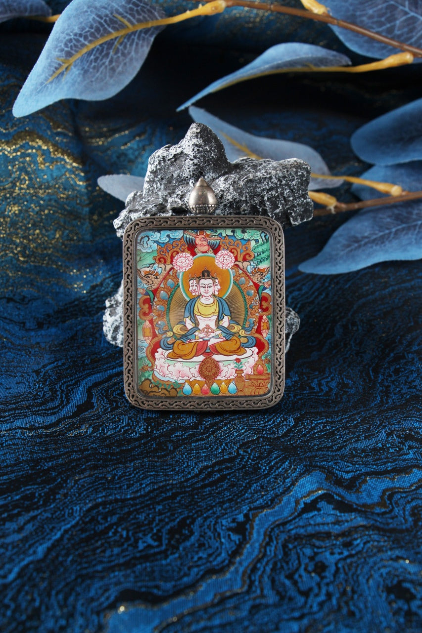 Front view of a Vairocana Buddha mini thangka card in a silver gawu-style pendant case, hand-painted in Menri style with mineral pigments.