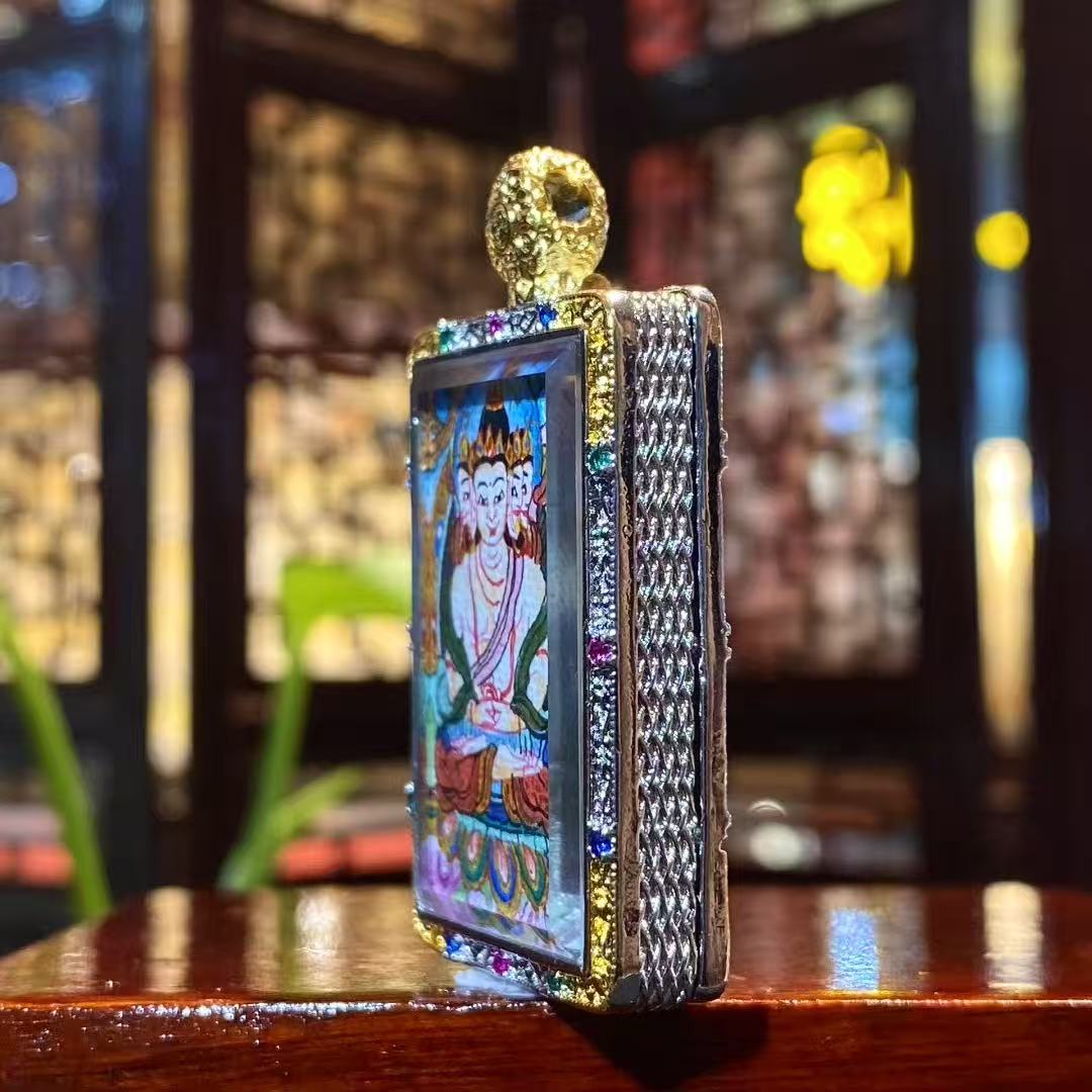 Close-up detail of a hand-painted Vairocana Buddha mini thangka pendant in a gold-plated Tibetan Gawu box, 25×35mm