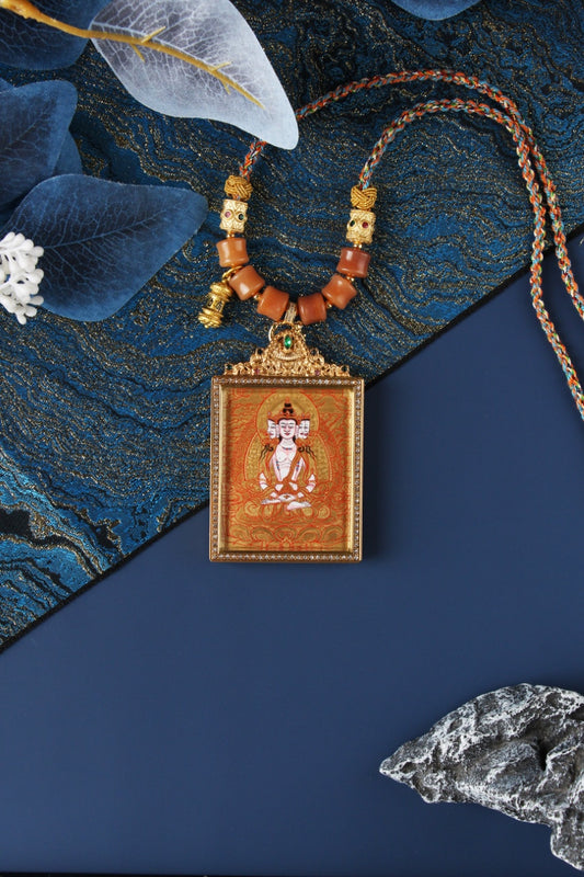 Hand-painted Vairocana Buddha mini thangka pendant in Rebgong gold thangka style, featuring mineral pigment painting, square double-sided titanium steel case, and detailed ornamental top bail