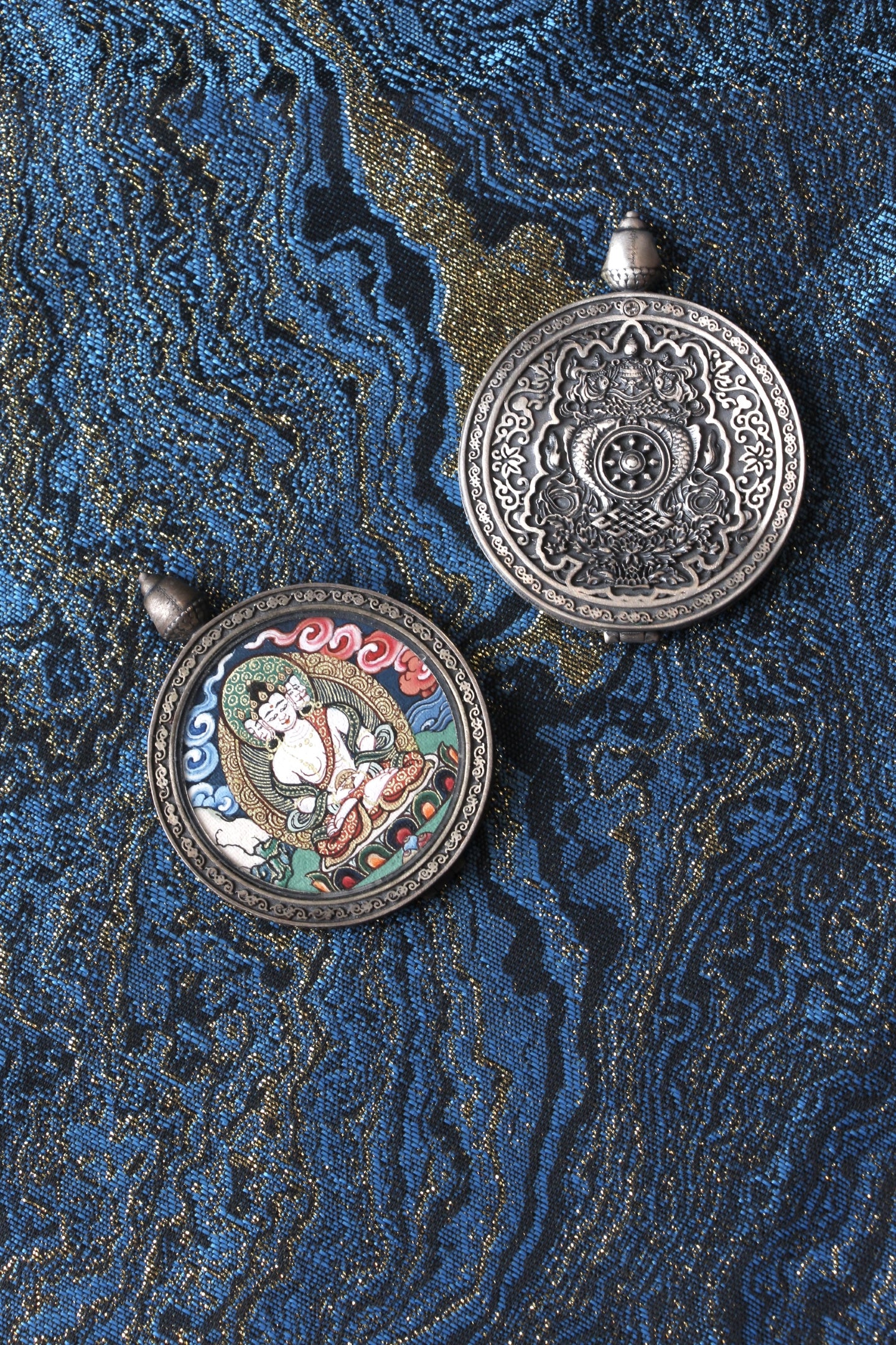 Back view of a double-sided Vairocana Buddha thangka pendant featuring an engraved 925 silver relief design, traditional Tibetan Buddhist ornamentation, crafted as a wearable devotional pendant.