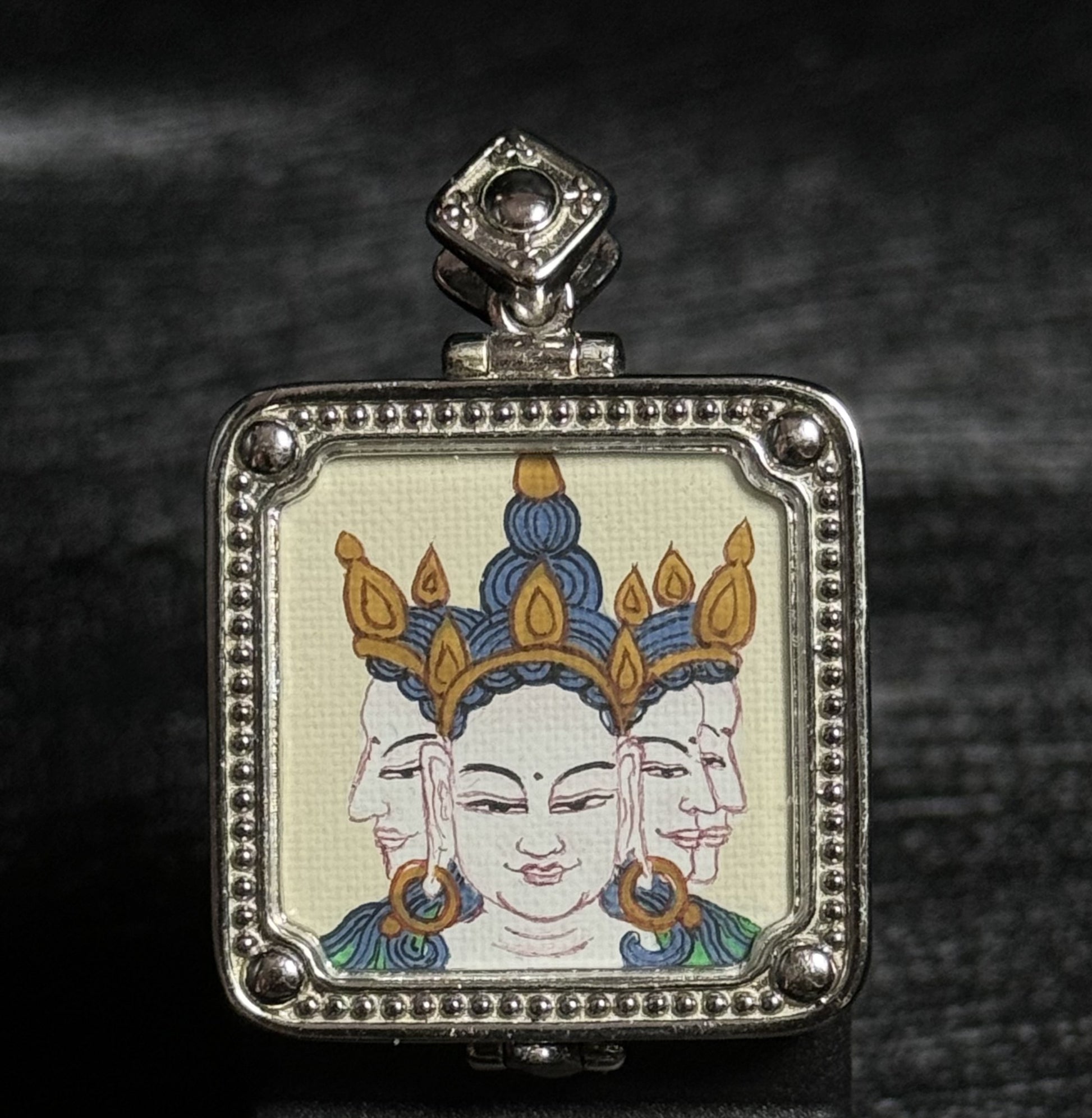 Hand-painted Vairocana Buddha mini thangka pendant from Tibet, created by a master artist with mineral pigments, mounted in a 925 silver-plated setting, 2×2 cm
