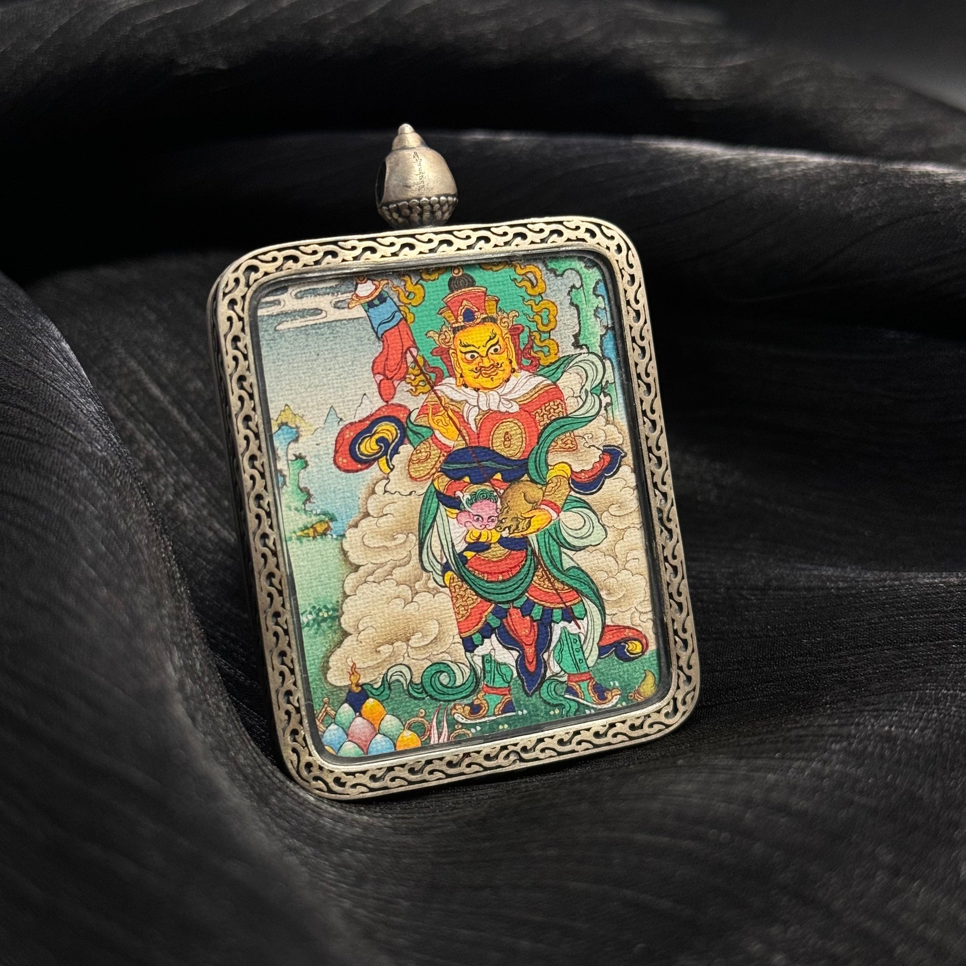 Detailed view of Vaishravana Northern Guardian King deity painting in mini thangka pendant with traditional Tibetan iconography