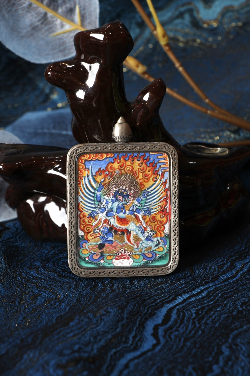 Front view of a Vajrakilaya (Dorje Phurba) mini thangka pendant, fully hand-painted with natural mineral pigments in the Rebgong Tibetan style, set in a Dunhuang Nine-Colored Deer pure silver case.