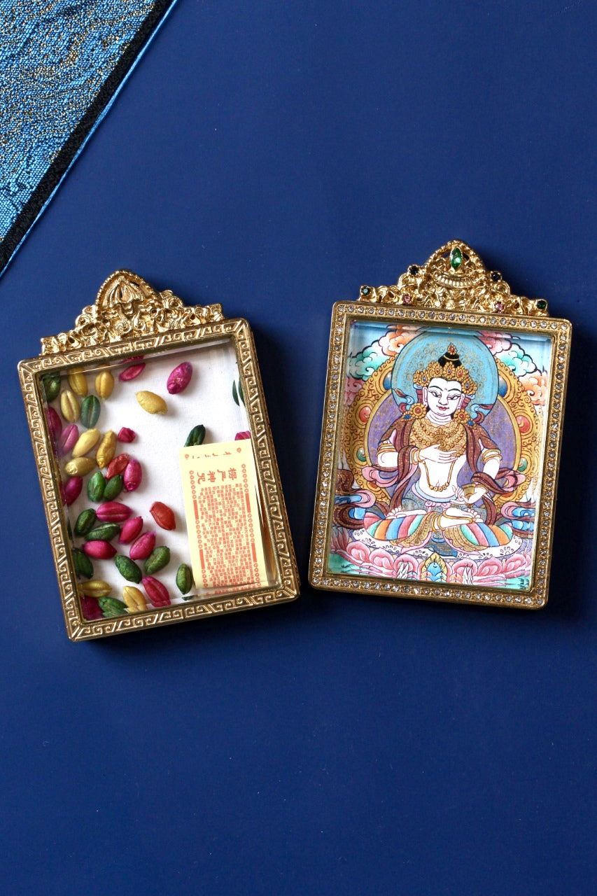 Open case view of Vajrasattva mini thangka pendant showing the double-sided jeweled titanium steel frame and inner compartment layout, Nepal high-end series
