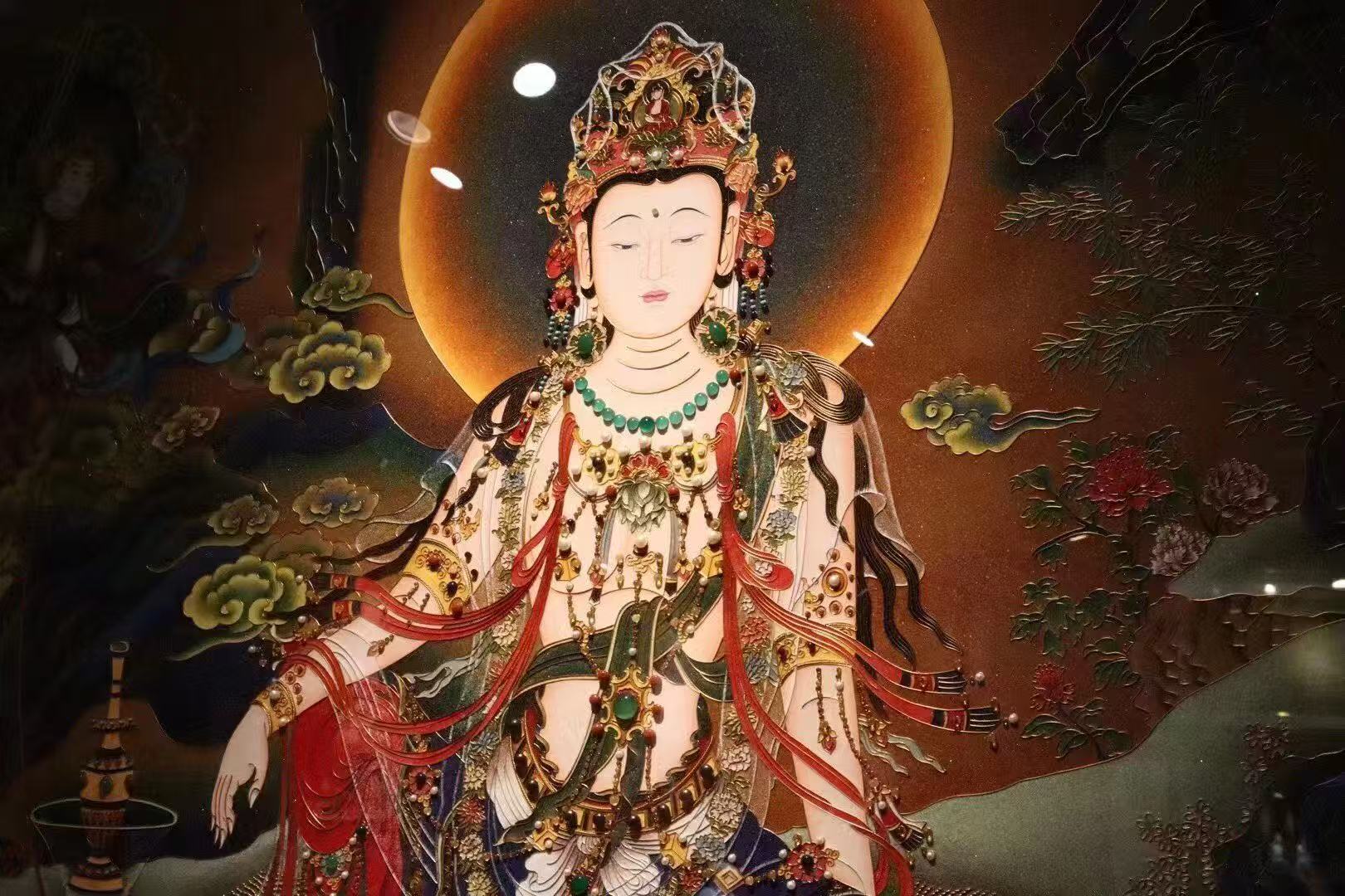 Close-up detail of Water Moon Avalokiteshvara thangka showing relaxed royal-ease seated posture, flowing robes, refined line work, and traditional Rebgong iconography painted with natural mineral pigments