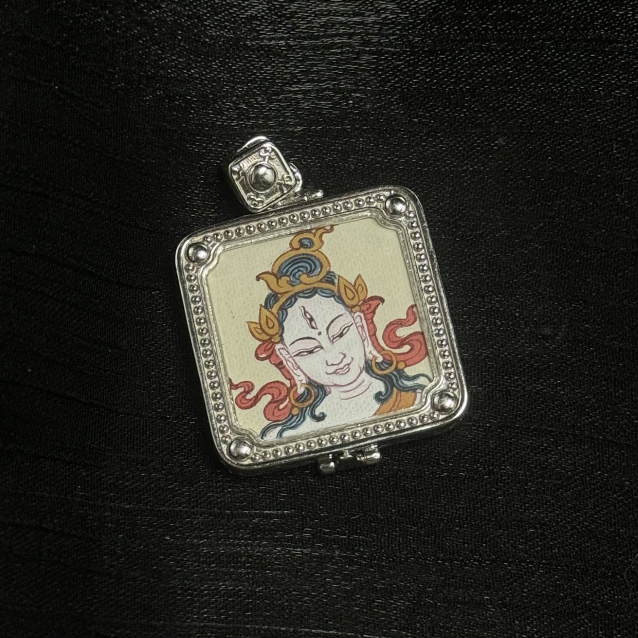 Square White Tara pendant featuring hand-painted Tibetan Buddha head artwork, set in a 925 silver-plated amulet pendant frame.