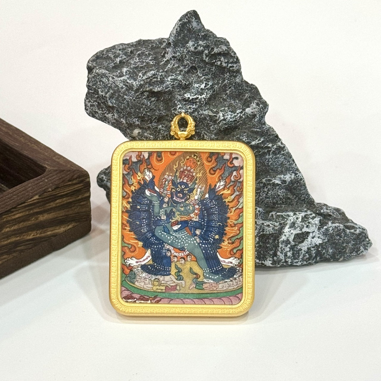 Close-up of Yamantaka mini thangka painting, showing fine line work, dense mineral pigment application, and traditional Tibetan wrathful deity composition.