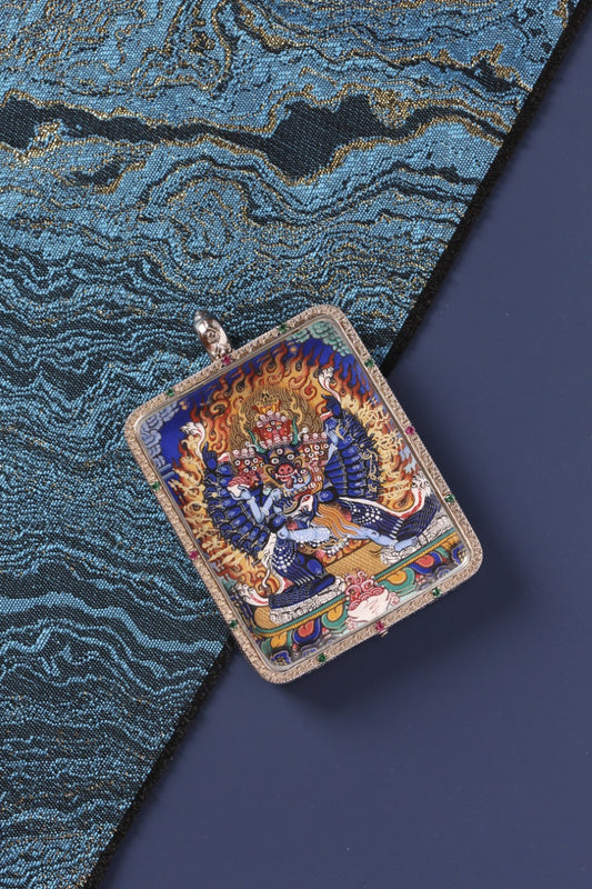 Close-up of the Yamantaka mini thangka pendant highlighting intricate hand-painted details, Rebgong-style iconographic structure, and mineral pigment color layering within a sterling silver frame.