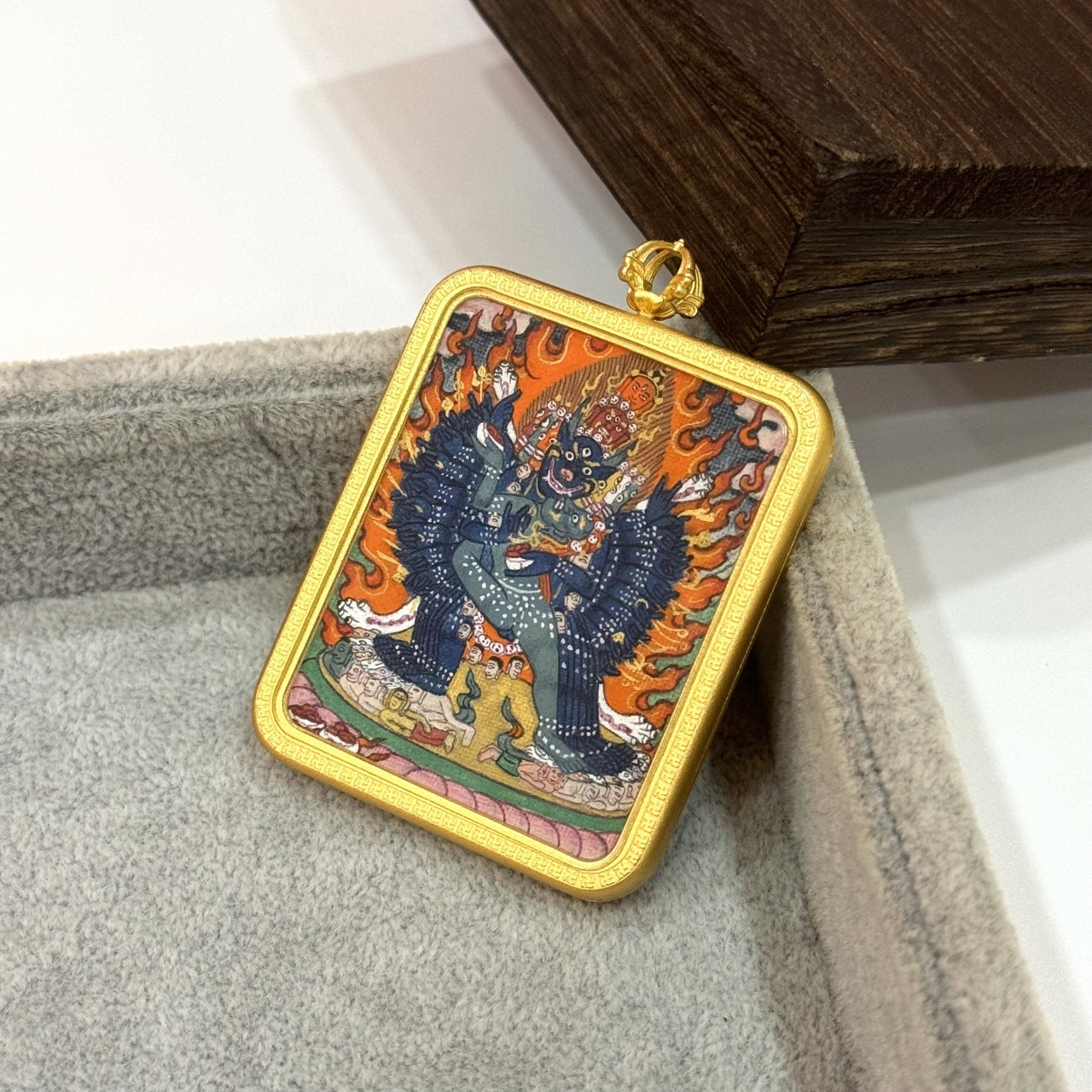 Yamantaka mini thangka pendant displayed upright, featuring a traditional Tibetan copper case and a fully hand-painted mineral pigment artwork.