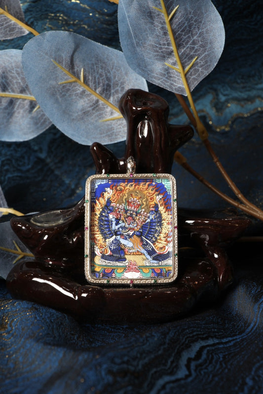 Front view of a Yamantaka (Vajrabhairava) mini thangka pendant, fully hand-painted with natural mineral pigments in the Rebgong Tibetan style, set in a 925 sterling silver pendant case.