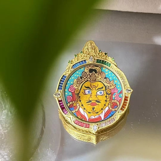 Front view of hand-painted Yellow Jambhala Thangka set in an ornate rainbow Tibetan Gawu pendant with gemstone details