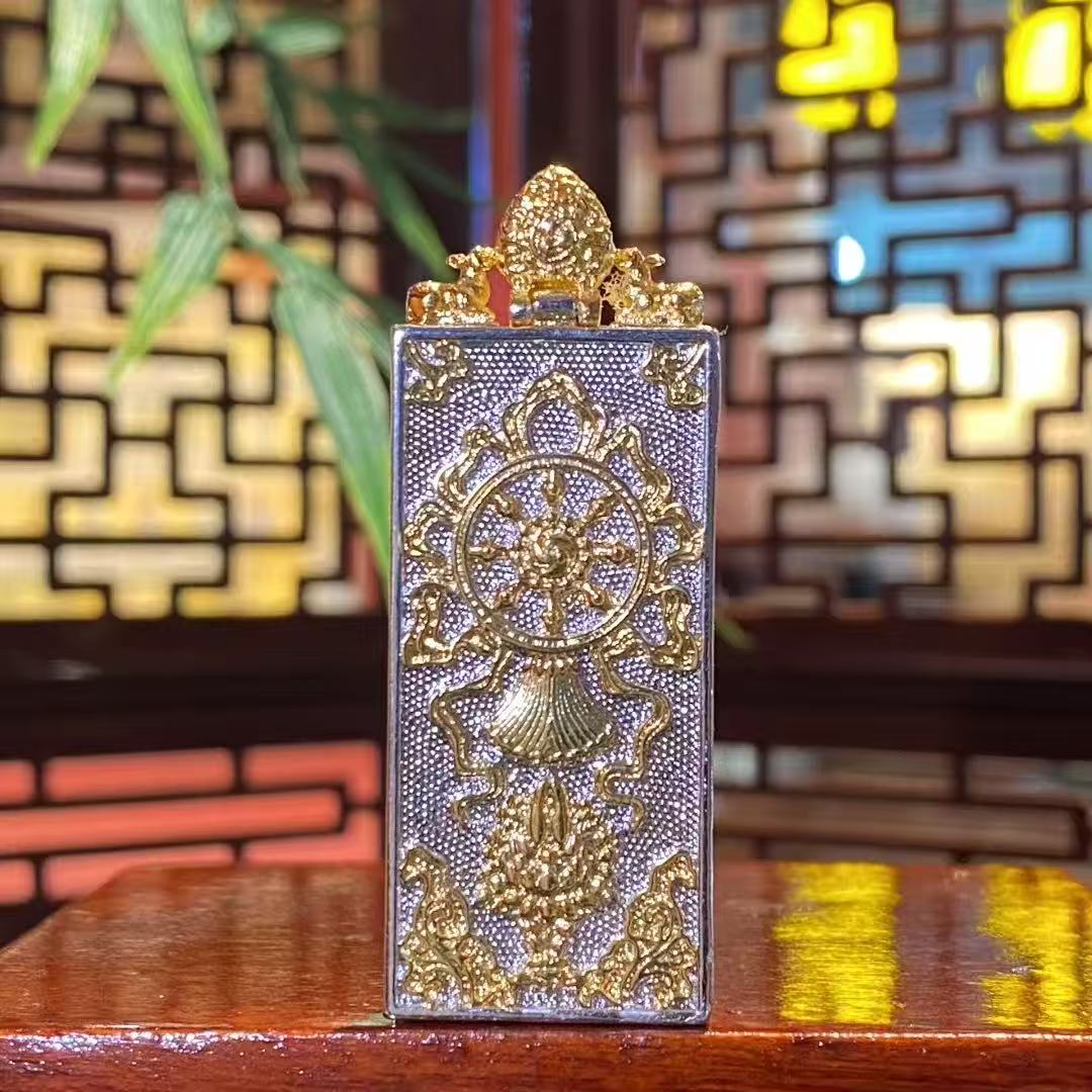 Back view of the copper Gau box for a Yellow Jambhala mini Thangka pendant, featuring protective Buddhist symbols