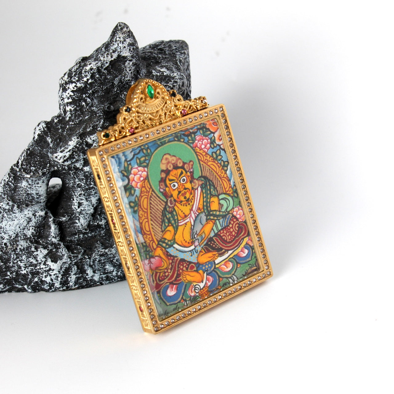 Front view of Yellow Jambhala mini thangka pendant highlighting vivid hand-painted deity details, lotus seat motifs, and the crystal-trimmed gold-tone titanium steel frame