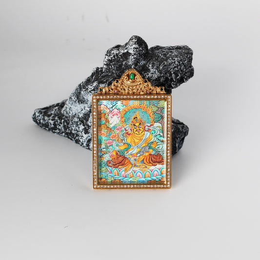 Front view of Yellow Jambhala mini thangka pendant, hand-painted with mineral pigments, rich gold-toned palette, enclosed in a double-sided jewelry-grade titanium steel case with detailed ornamentation