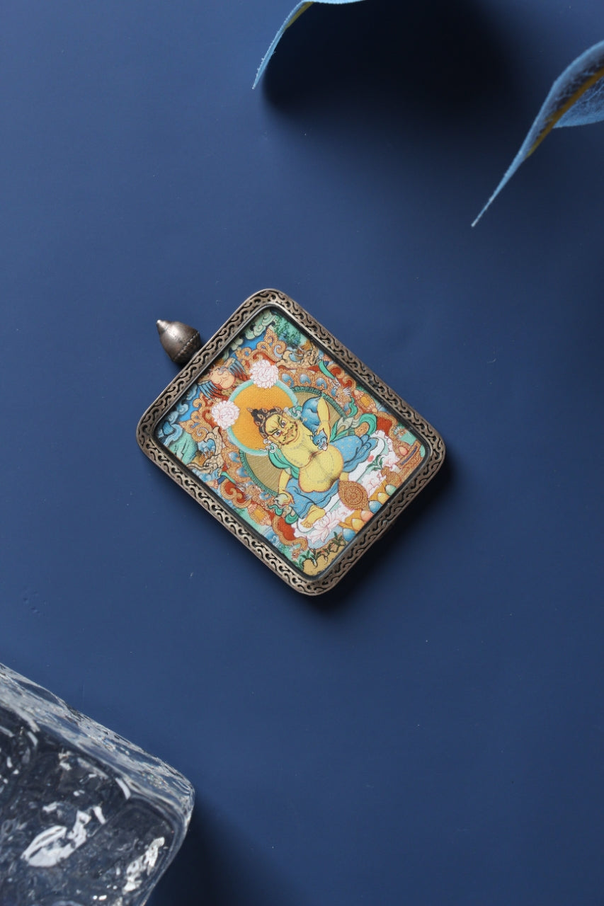 Yellow Jambhala mini thangka pendant in Menri style, Tibetan Buddhist wealth deity artwork suitable for personal wearing or close meditation