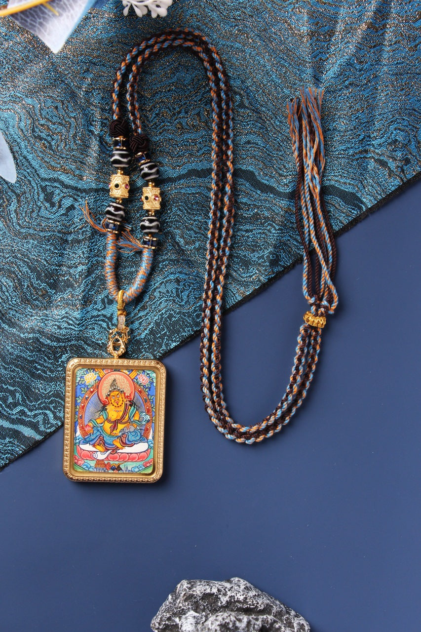 Complete Yellow Jambhala thangka pendant necklace, including hand-painted mini thangka, titanium steel frame, decorative beads, and traditional braided cord, crafted in Rebgong tradition.
