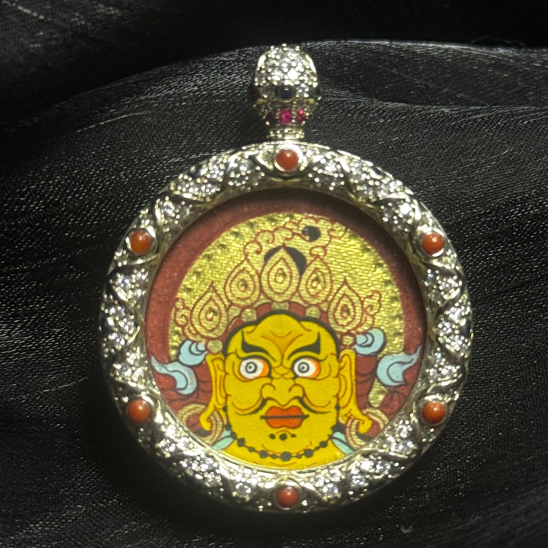 Rebgong hand-painted Yellow Jambhala mini thangka pendant with red cinnabar background and layered gold details, 3 cm painting size in jewelry-grade copper case