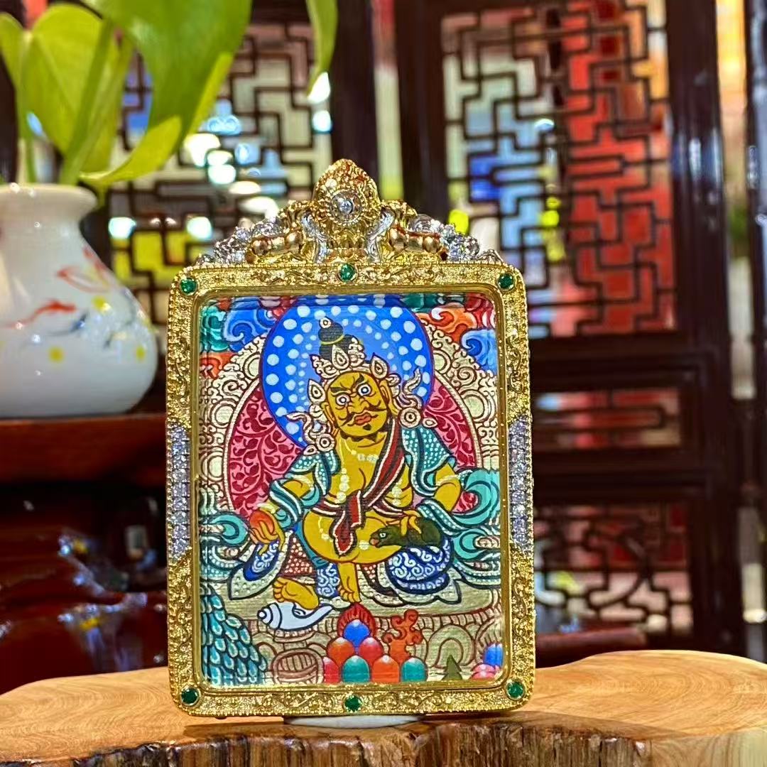 Hand-painted Yellow Jambhala mini Thangka pendant in a gilded copper Gau box, featuring the Tibetan God of Wealth