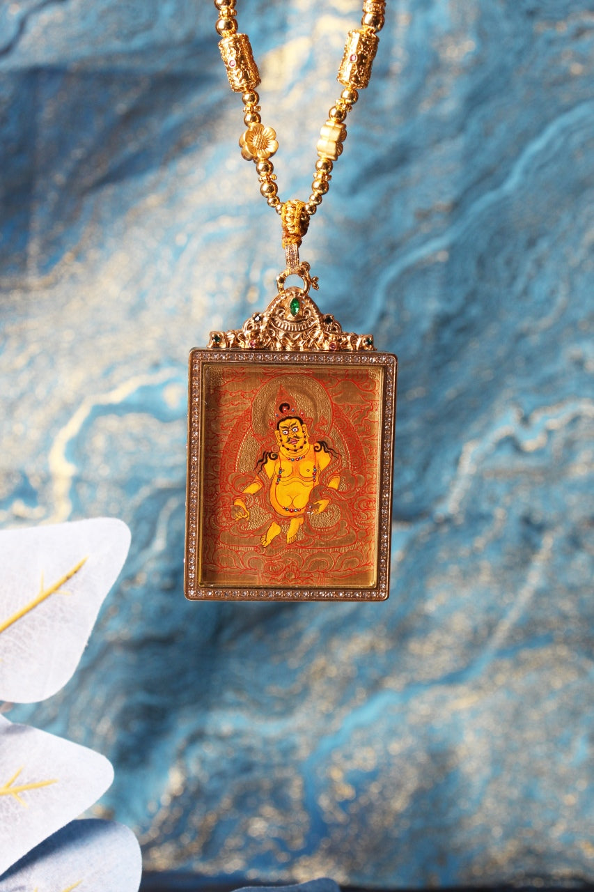 Yellow Jambhala Rebgong gold thangka pendant displayed as a wearable necklace, emphasizing balanced proportions, decorative bead elements, and pendant format.