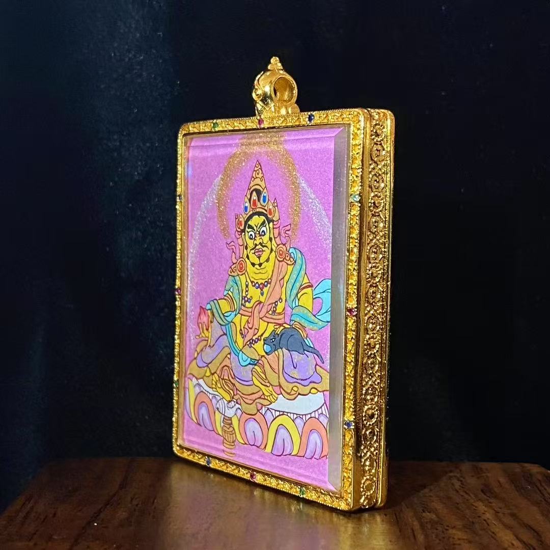 Side view of a Yellow Jambhala hand-painted mini Thangka pendant showing the traditional copper Gau box structure