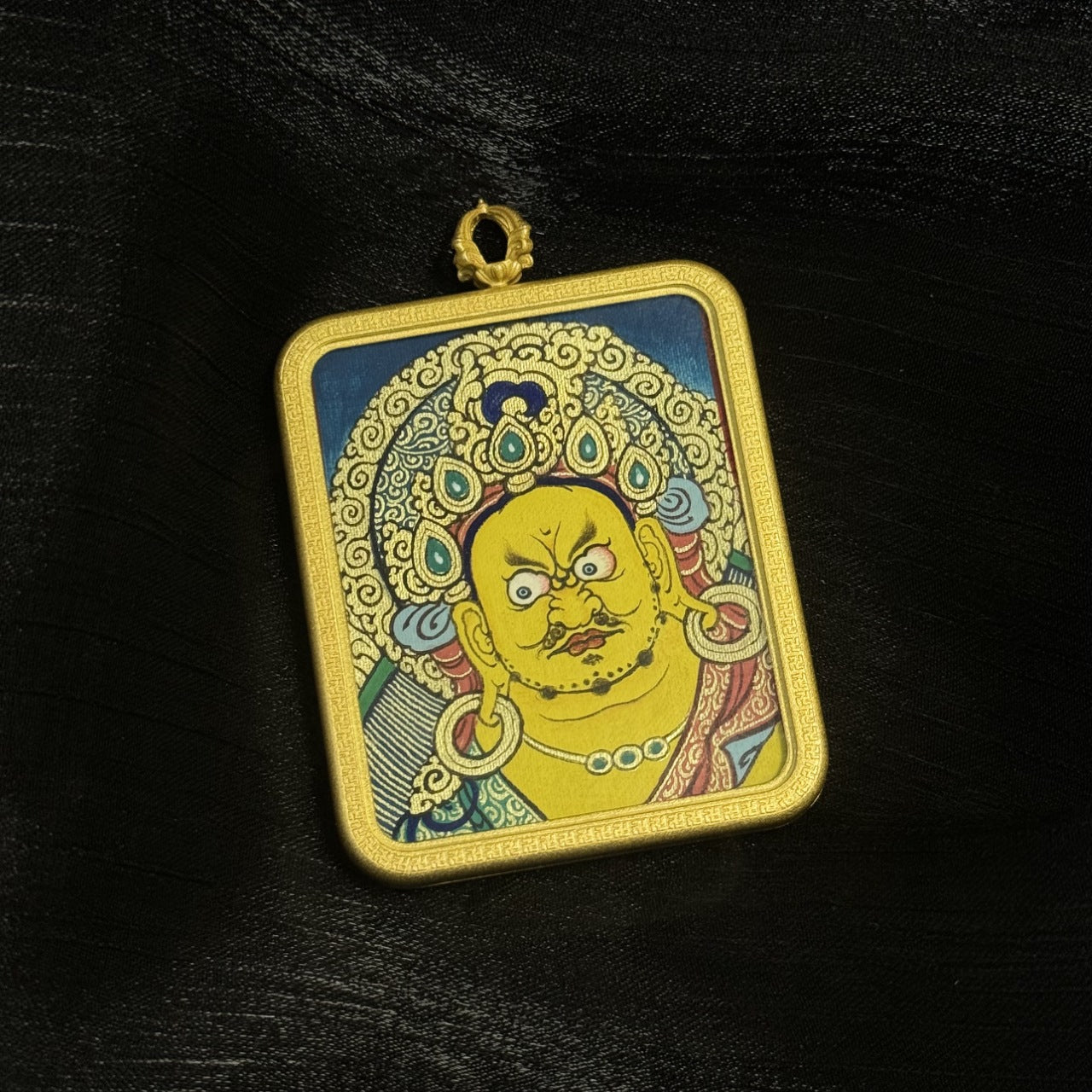 Front display of Yellow Jambhala thangka pendant highlighting traditional Tibetan wealth deity portrait with mineral pigment colors