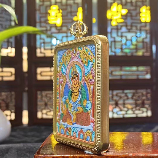 Side view of Tibetan Yellow Jambhala Gawu pendant showing titanium steel construction and solid thickness