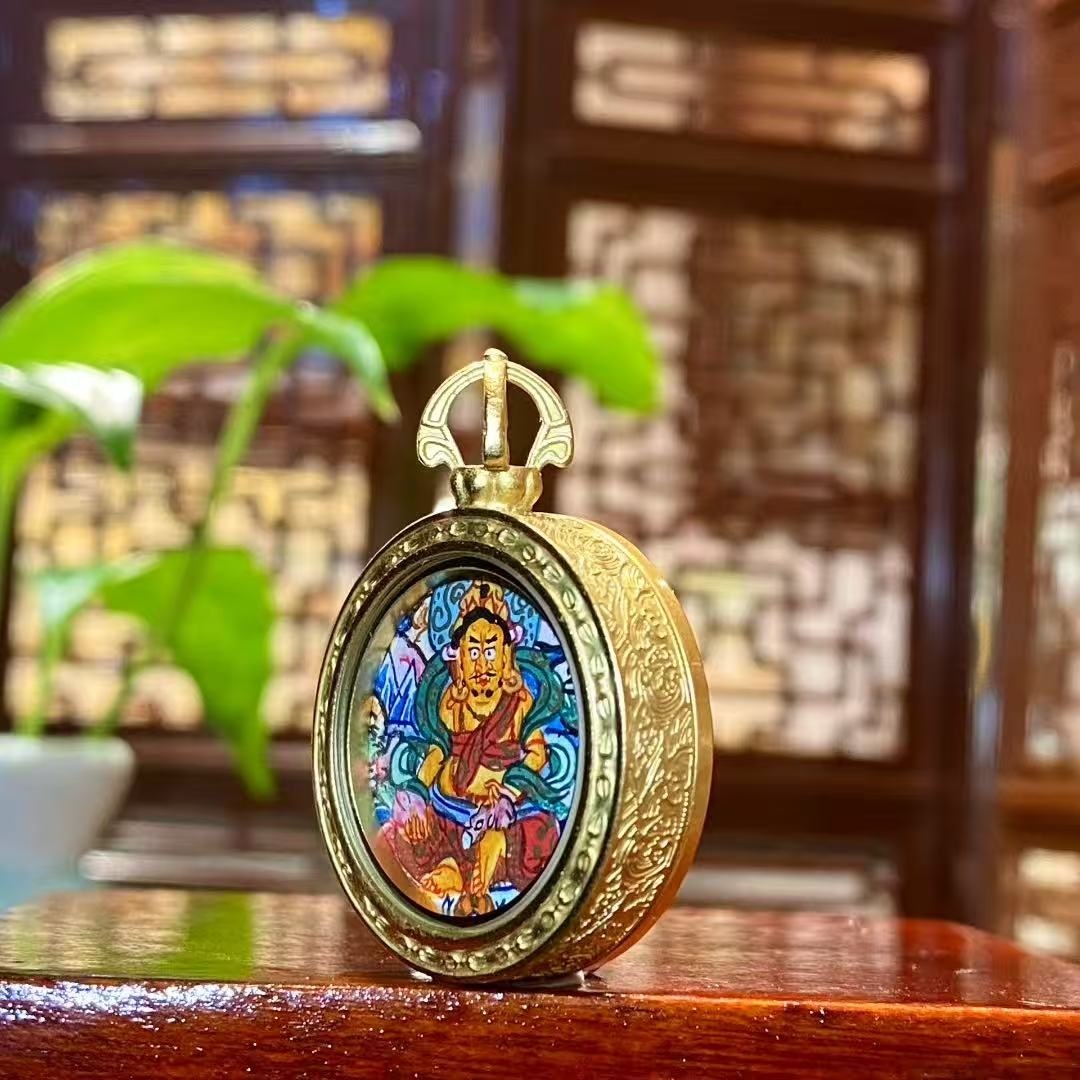 Side view of Tibetan Yellow Jambhala Gawu pendant showing titanium steel construction and balanced thickness