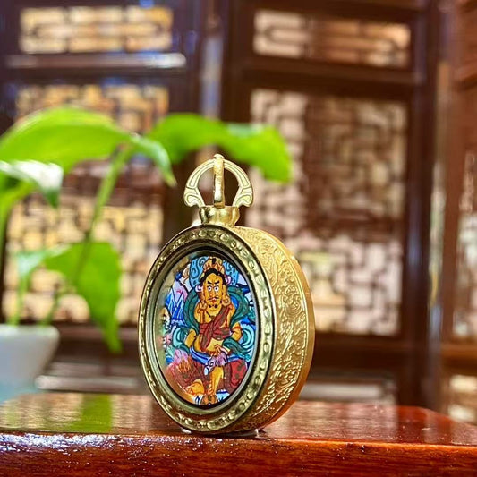 Side view of Tibetan Yellow Jambhala Gawu pendant showing titanium steel construction and balanced thickness