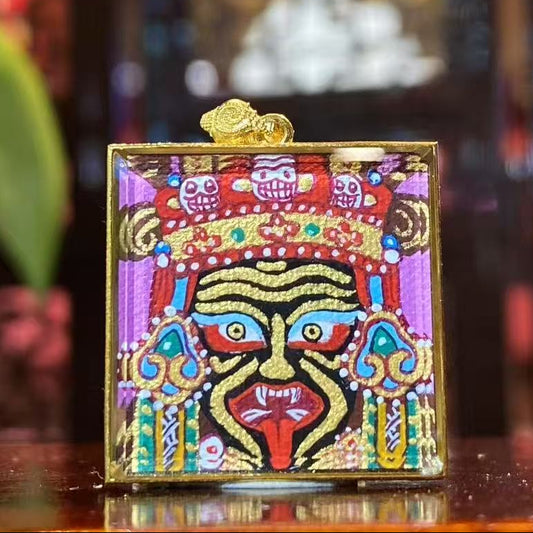 Front view of Zaki Lhamo Tibetan Thangka pendant, double-sided and hand-painted in 18K gold, Rebgong style, set in a traditional Gawu box