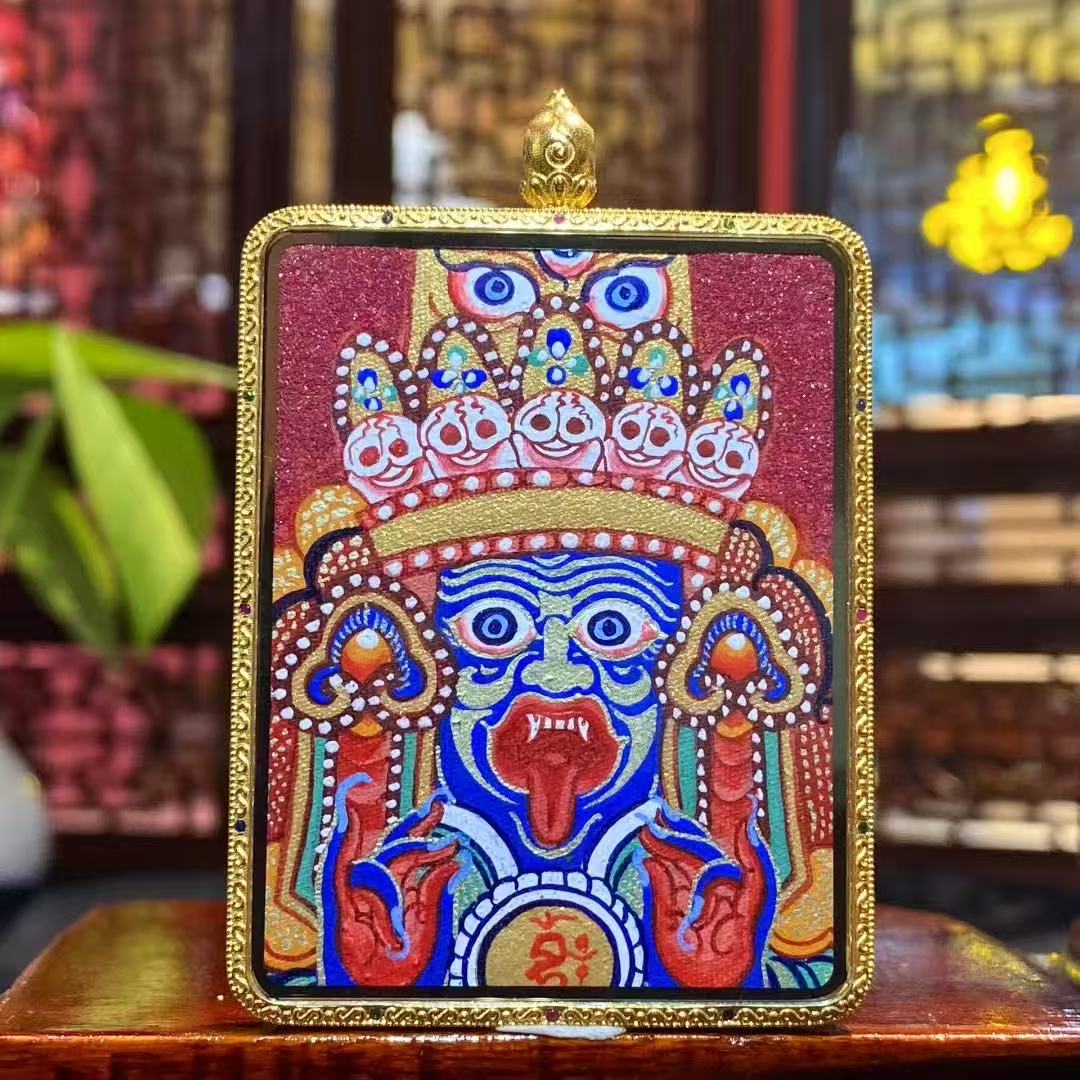 Front view of Zaki Lhamo Tibetan Thangka pendant, double-sided and fully hand-painted in 18K gold, Rebgong style, set in a large traditional Gawu box