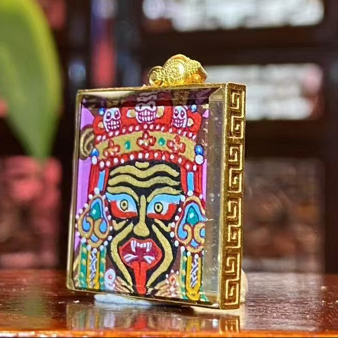 Side view of Tibetan Gawu box pendant featuring a double-sided 18K gold hand-painted Thangka, sapphire crystal cover, portable shrine design
