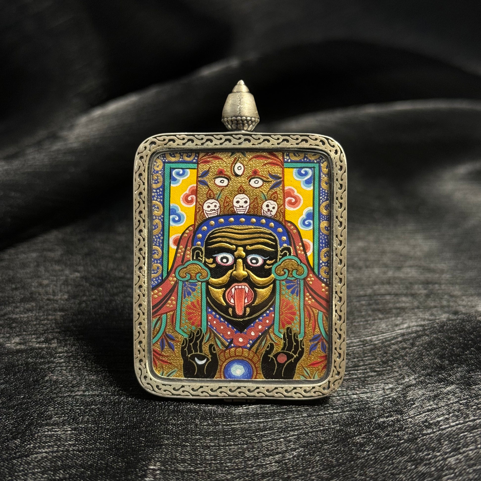 Front view of Zaki Lhamo gold relief mini thangka pendant featuring layered gold powder painting, vivid mineral pigments, and a finely crafted 925 silver pendant frame.