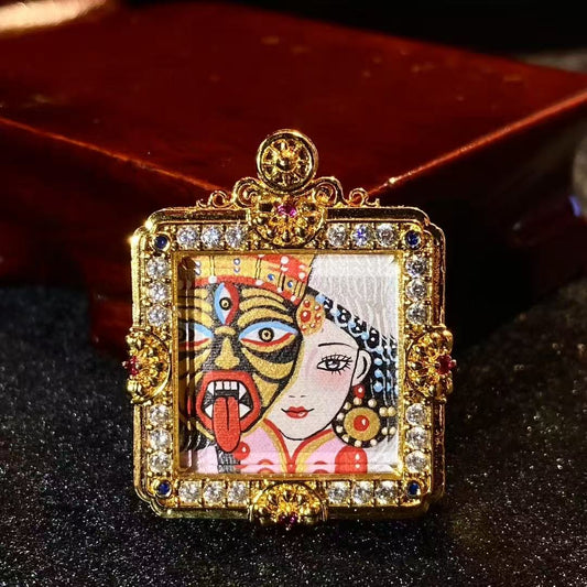 Front view of a hand-painted Zaki Lhamo mini thangka pendant in a compact rectangular copper gau box, showing fine details within a small format