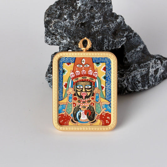 Front view of a Zaki Lhamo mini thangka pendant, hand-painted with natural mineral pigments on a blue ground and set in a traditional copper case from Rebgong.