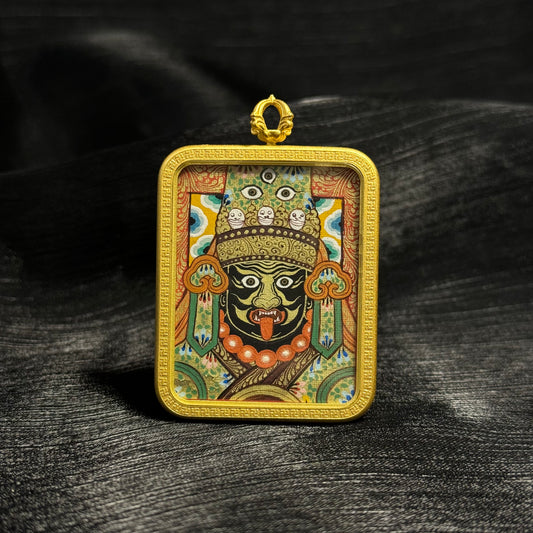 Front view of Zaki Lhamo mini thangka pendant featuring a hand-painted Rebgong thangka portrait with mineral pigments, gold powder detailing, and a textured gold frame setting.