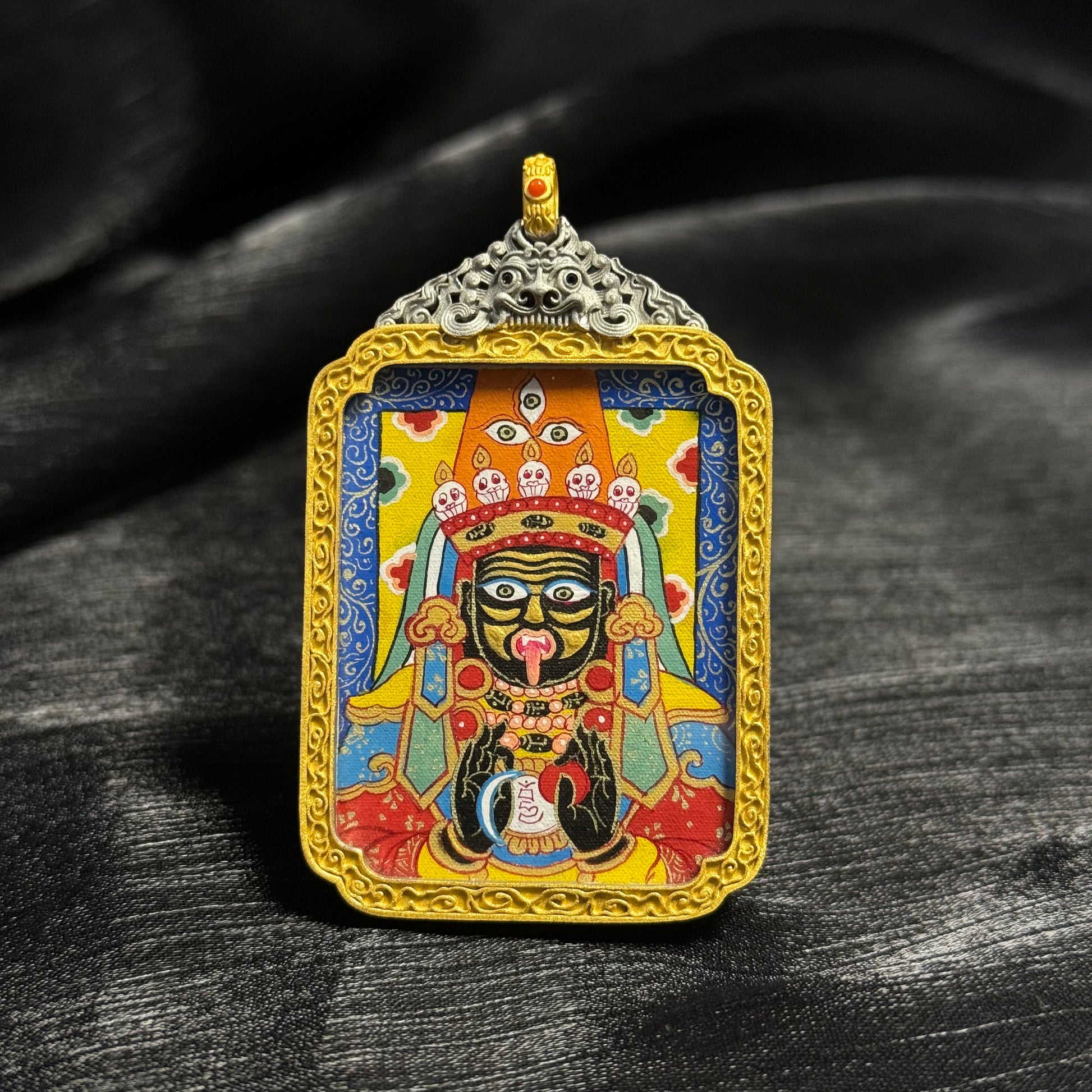 Front view of Zaki Lhamo mini thangka pendant featuring hand-painted Rebgong mineral pigment artwork with detailed deity face and decorative gold frame.