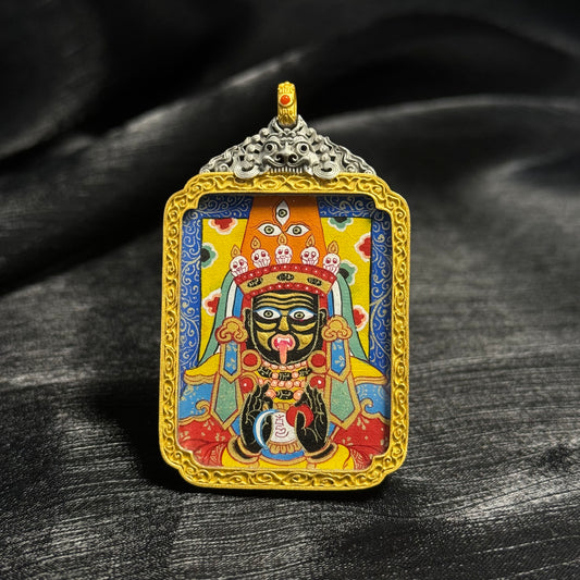 Front view of Zaki Lhamo mini thangka pendant featuring hand-painted Rebgong mineral pigment artwork with detailed deity face and decorative gold frame.