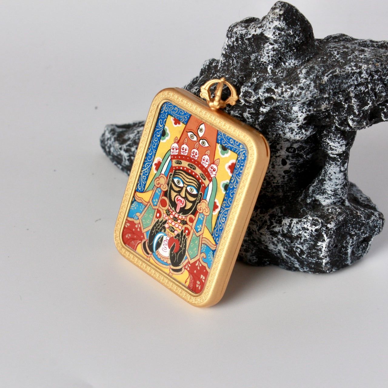 Side profile of the Zaki Lhamo mini thangka pendant highlighting the handcrafted copper casing and clean edge finishing.
