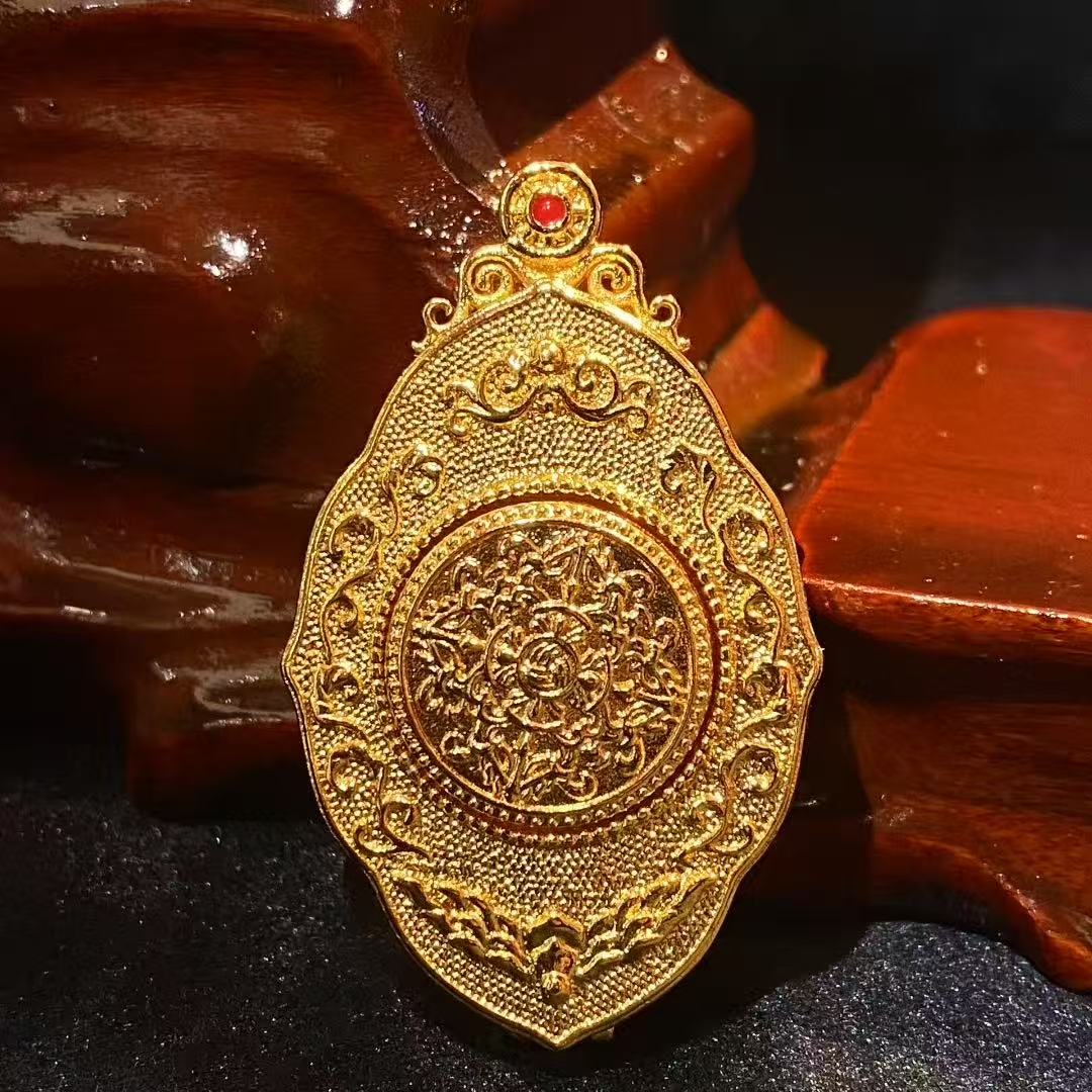 Back view of the sculpted copper gau box of the Zaki Lhamo thangka pendant, emphasizing its unique shape and ornamental metal craftsmanship