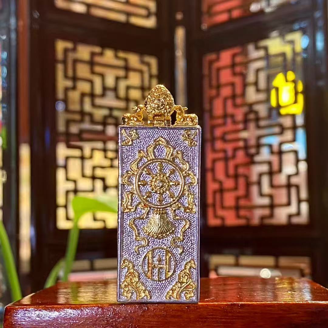 Back view of the Zaki Lhamo thangka pendant featuring a traditional Tibetan gau box design with engraved stupa motif and decorative metalwork