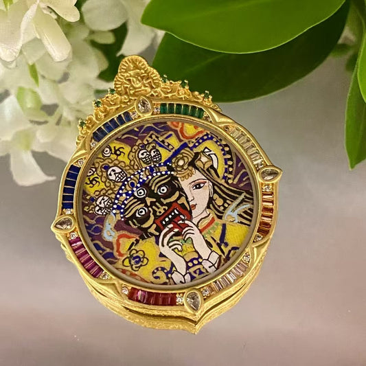 Front view of a hand-painted Zaki Lhamo thangka pendant depicting the Tibetan guardian goddess, set in a circular rainbow copper gau box