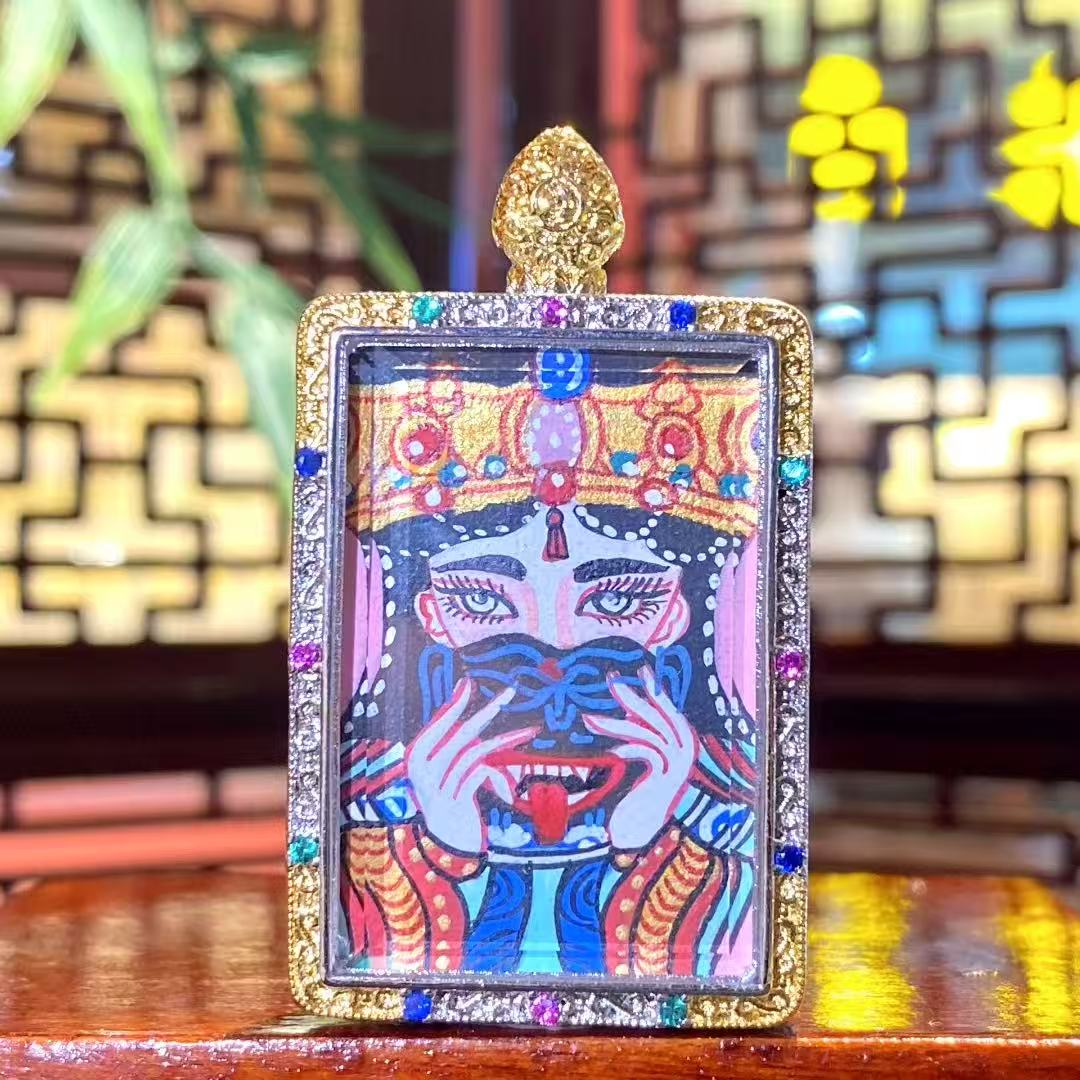 Front view of a hand-painted Zaki Lhamo thangka pendant depicting the Tibetan guardian goddess, set in a traditional copper gau box